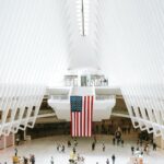 Highly Rewarding Jobs in the USA for Skilled Workers with Visa Sponsorship A breathtaking view of the Oculus in New York City, showcasing its iconic architecture with a prominent American flag.