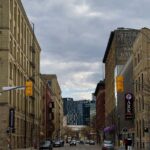 Vibrant downtown Winnipeg street scene with historical architecture and modern buildings.