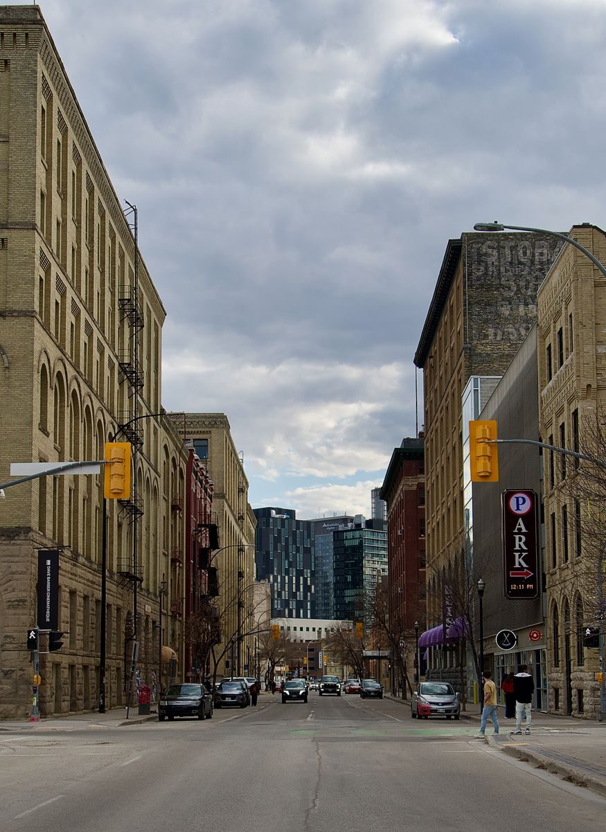 Vibrant downtown Winnipeg street scene with historical architecture and modern buildings.