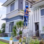 Domestic Jobs in Canada With Visa Sponsorship man in blue and orange jacket and blue pants standing on white metal ladder during daytime